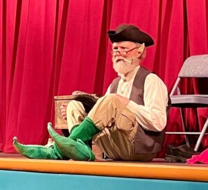 Hal Pratt in green boots on a stage