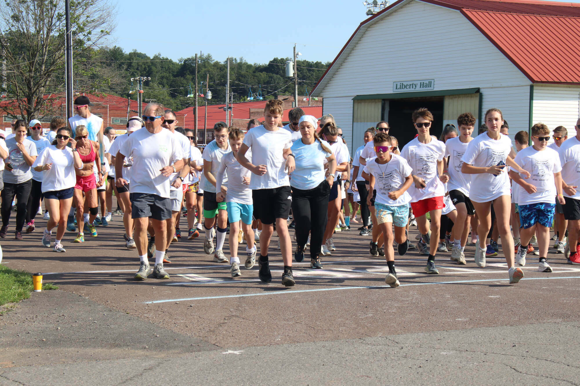 Runners in white t-shirts begin a race